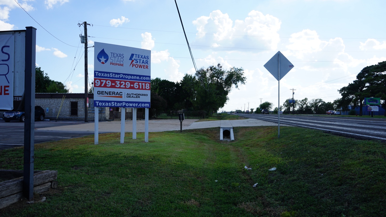 Roadside signage shot showing company branding and phone number.
