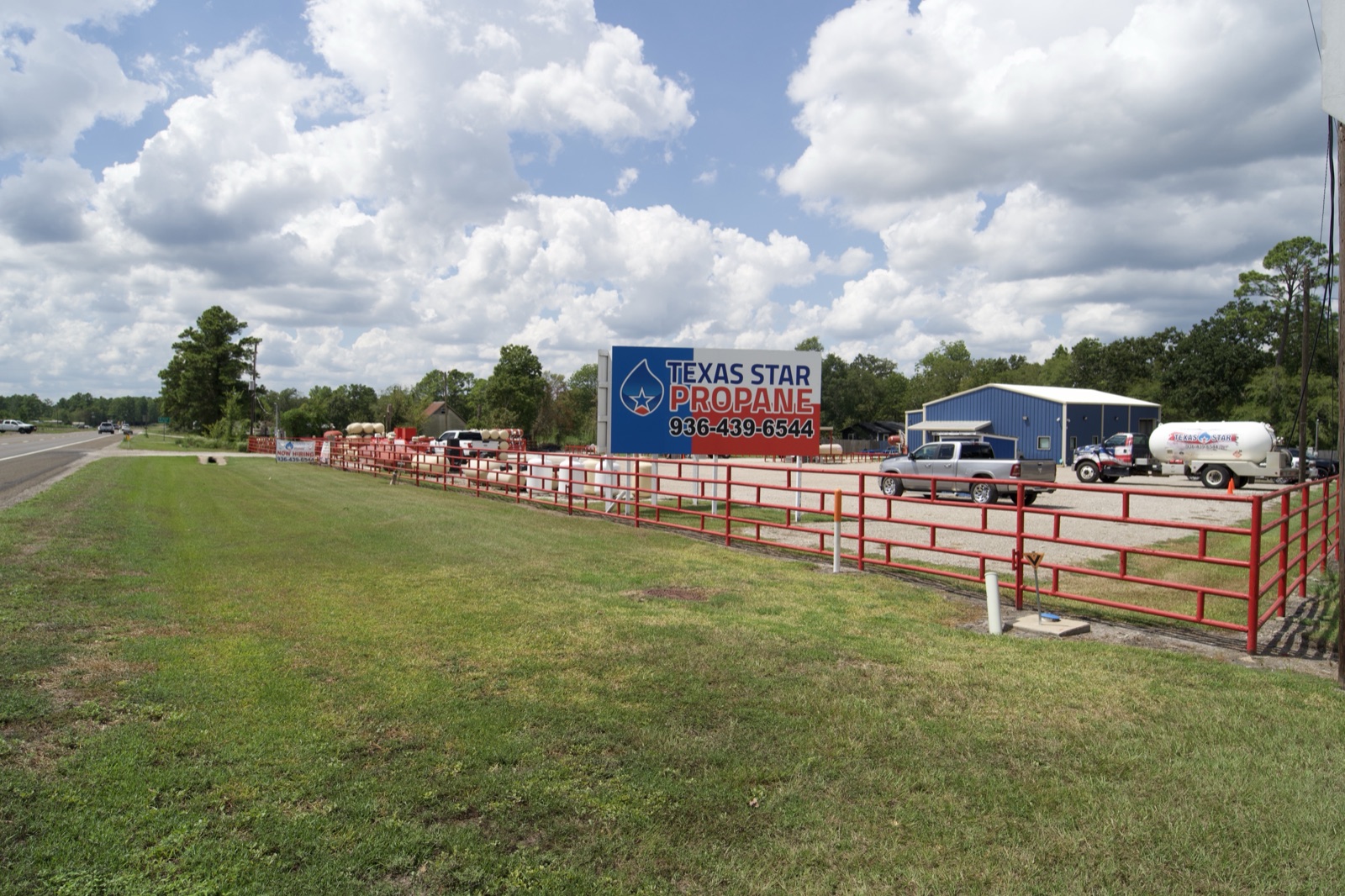 The propane yard with signage and trucks.