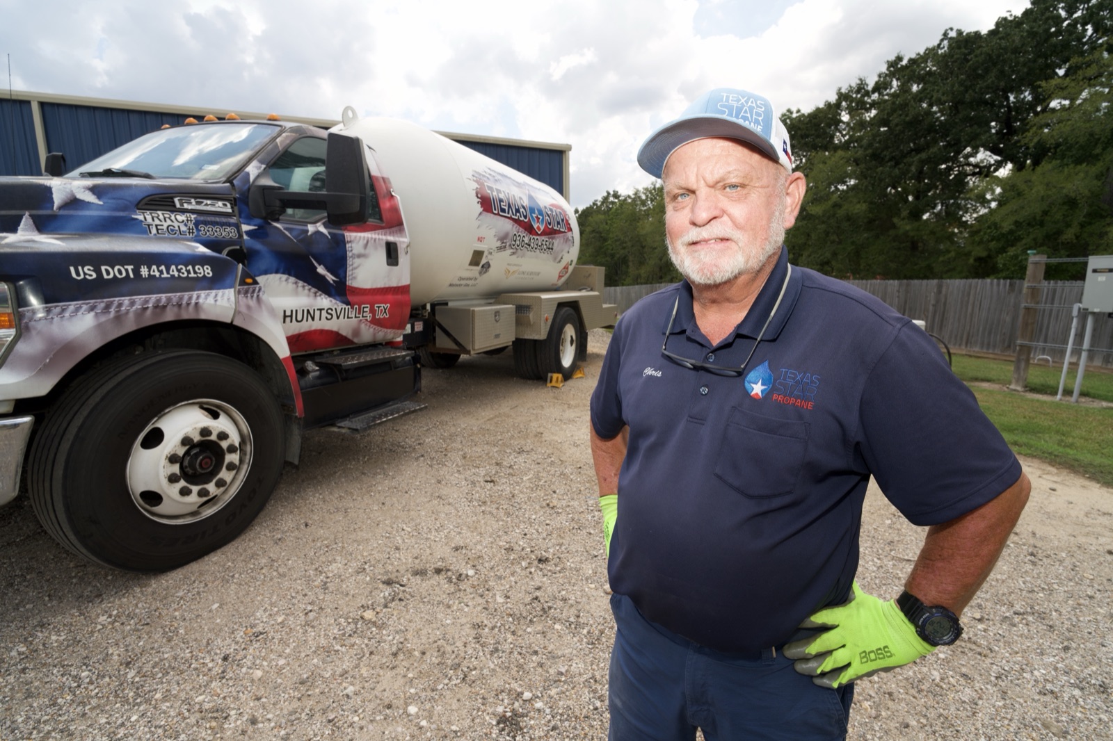 A Texas Star driver standing beside a branded truck.
