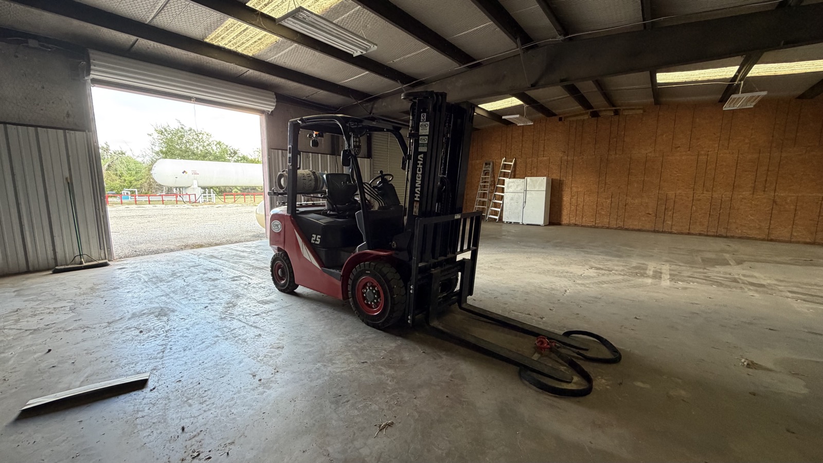 A propane powered forklift inside a warehouse.