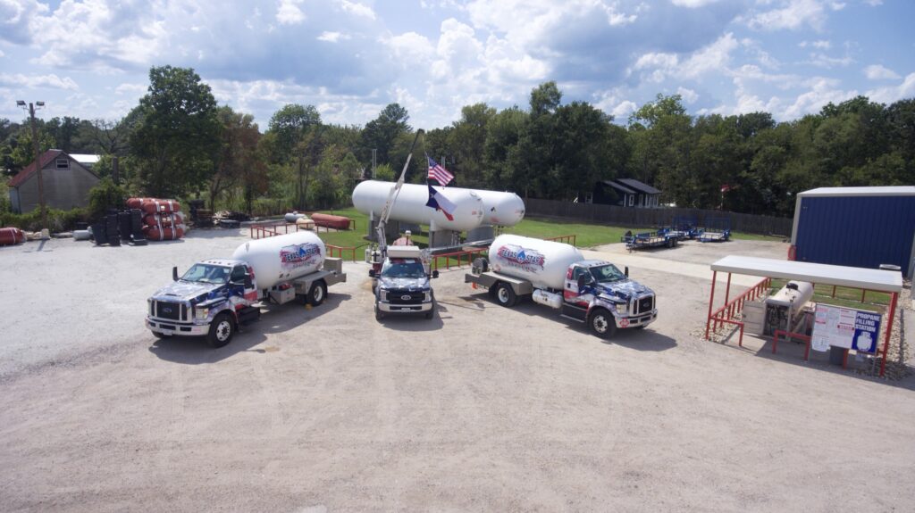 Aerial shot of three branded propane trucks and a large tank at the bulk plant.