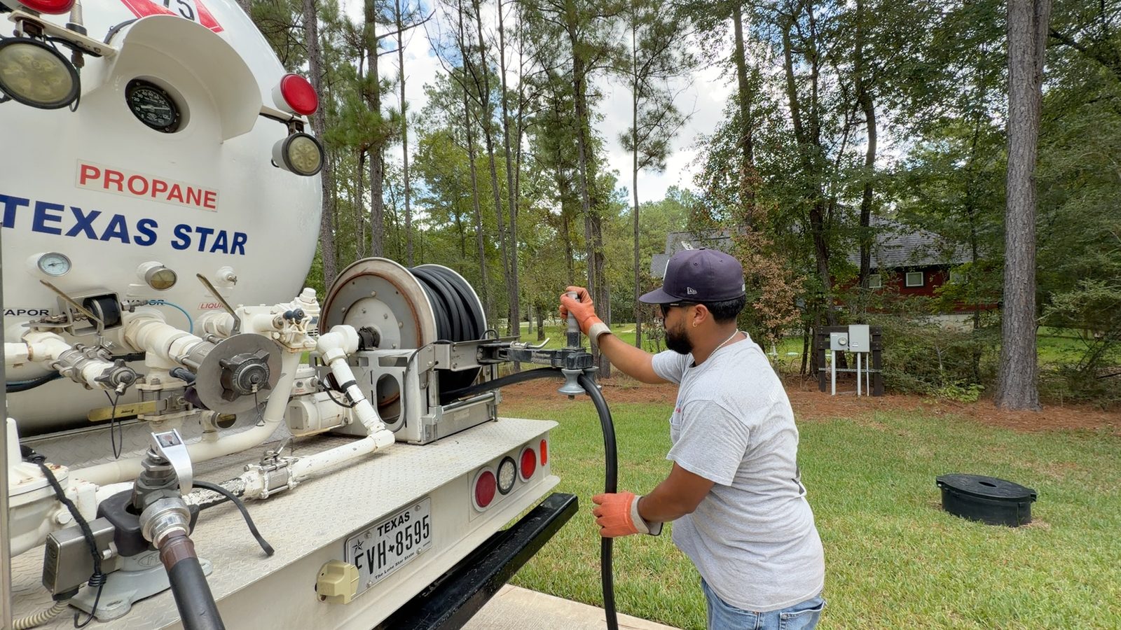 Bryan, TX technician refilling a propane tank from a delivery truck