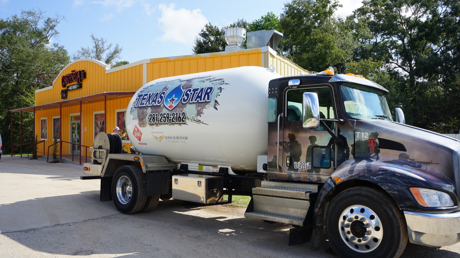 A Texas Star Propane truck making a delivery outside a restaurant.